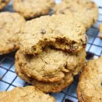 oatmeal raisin cookies stacked on a wire rack.