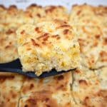 Cheddar Butter Swim Biscuits on a black spatula.