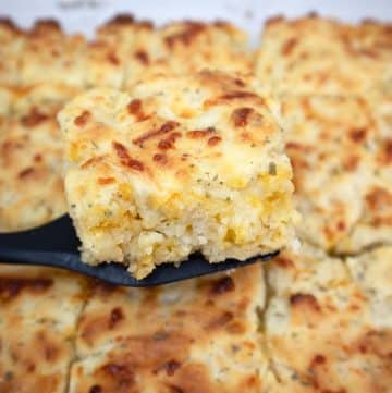 Cheddar Butter Swim Biscuits on a black spatula.