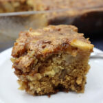 apple dapple cake served on a white plate with a fork.