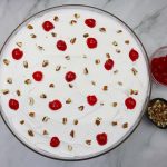 cherries and pecans sprinkled on top of cake.