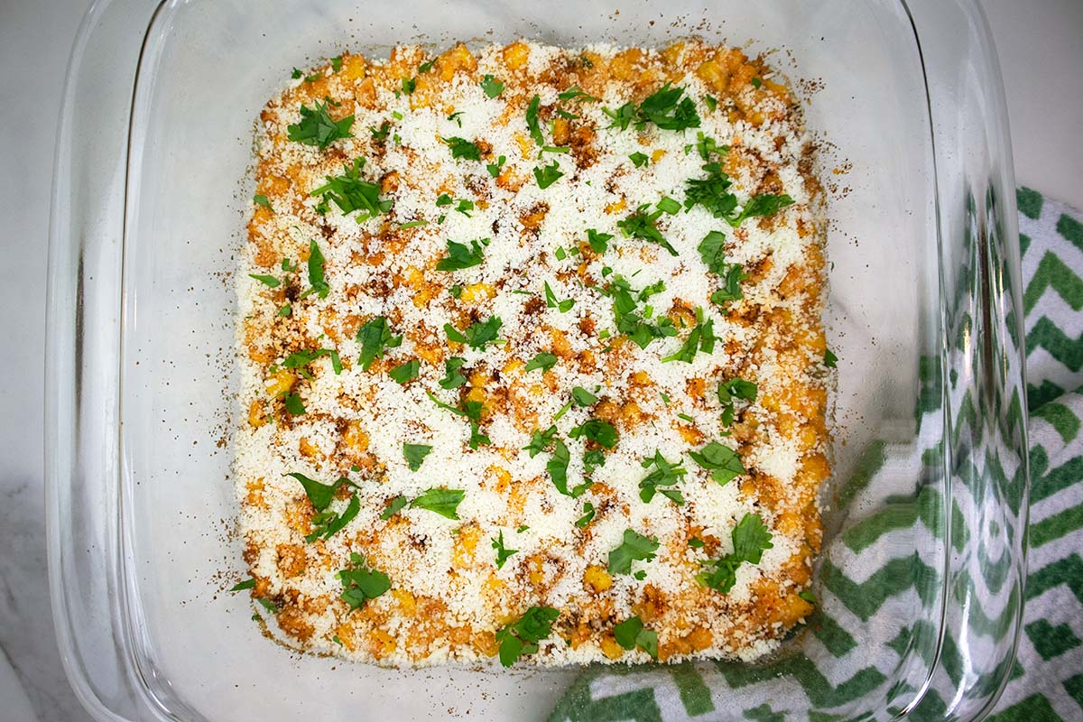 Baked mexican street corn bake in a glass dish.