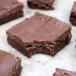 lunch lady brownies cut into slices and on top of parchment paper.