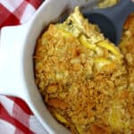 squash casserole served on a gray spoon.