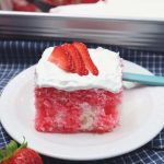 slice of jello poke cake on small white plate.