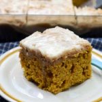 pumpkin coffee cake slice on a tan plate.