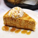 slice of pumpkin cheesecake on a small white plate.