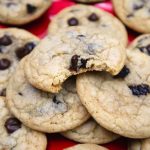 Chocolate chip cherry cookies stacked on a red plate.