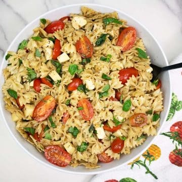 Caprese pasta salad in a large white bowl.