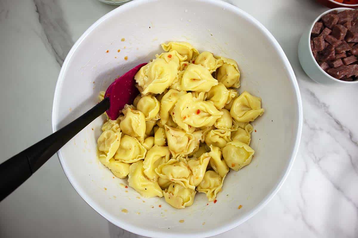 cooked tortellini in a large white bowl.