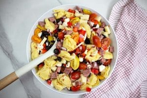 tortellini pasta salad in a large white bowl.