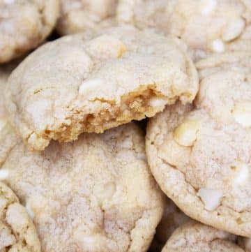 Stacked macadamia nut white chocolate cookies.