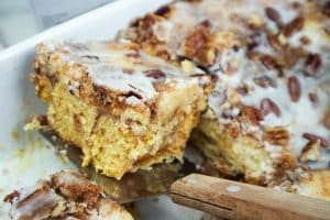 Sliced cinnamon roll dump cake on a metal spatula.