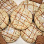 Baked stuffed cookie butter cookies with a Biscoff drizzle on top.