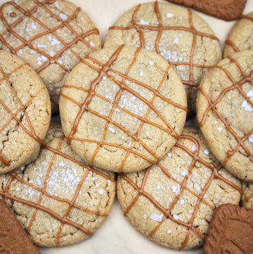 Baked stuffed cookie butter cookies with a Biscoff drizzle on top.