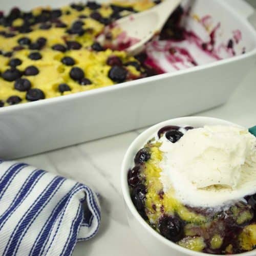 Lemon Blueberry dump cake in a small bowl and white baking dish.