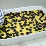 lemon blueberry dump cake in a white baking dish.