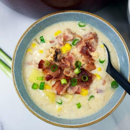 Chicken corn chowder soup in a blue bowl, ready to eat.