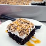 Better than sex cake slice on a white plate.