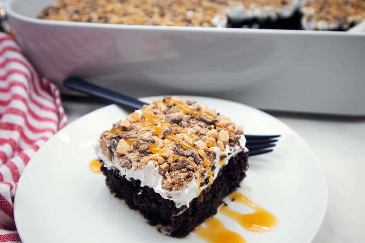 Better than sex cake slice on a white plate.