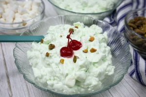 Watergate Salad or Pistachio Fluff served in a glass bowl.