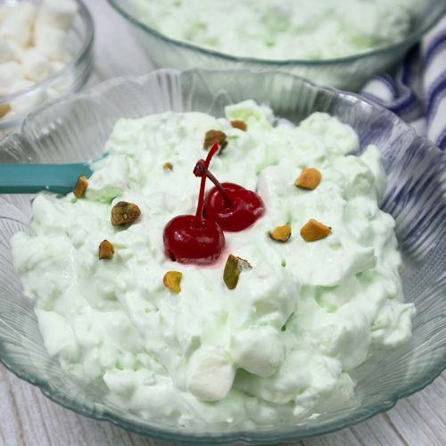 Watergate Salad or Pistachio Fluff served in a glass bowl.