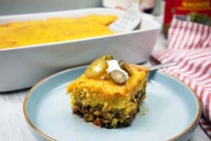 Mexican Cornbread Casserole sliced placed on a small blue plate.