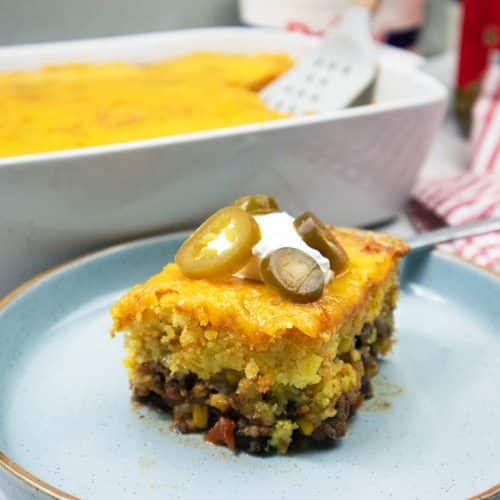 Mexican Cornbread Casserole sliced placed on a small blue plate.
